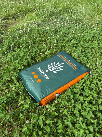 Green and orange Performance Blend soil bag with Riverview Living Soils Logo on grass